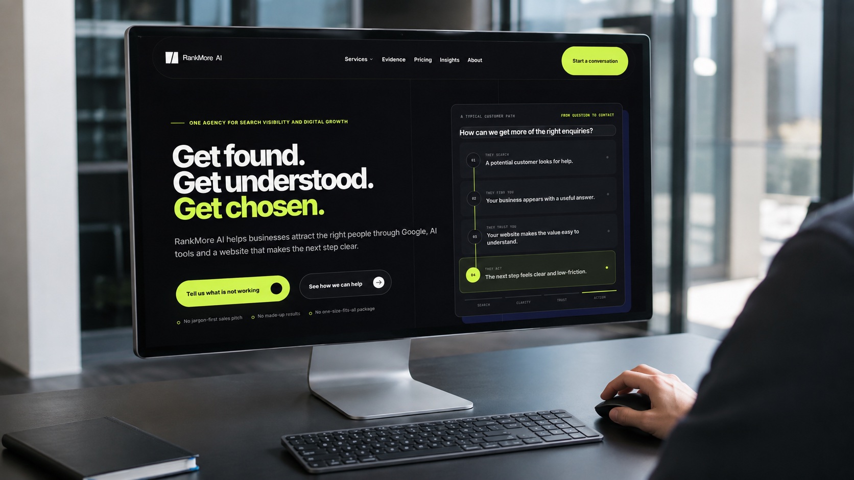 RankMore AI website displayed on a desktop monitor in a contemporary digital workspace.